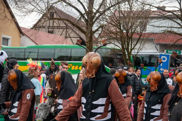 Hohenstadt - February 17, 2023: Participant of a parade in beetle masks and costumes at the traditional carnival parade in Hohenstadt, Germany.