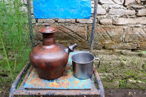 earthenware jug or teapot. a place to store water from clay. traditional vessels in the countryside. clay crafts.