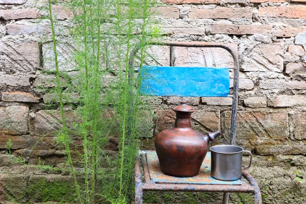 earthenware jug or teapot. a place to store water from clay. traditional vessels in the countryside. clay crafts.