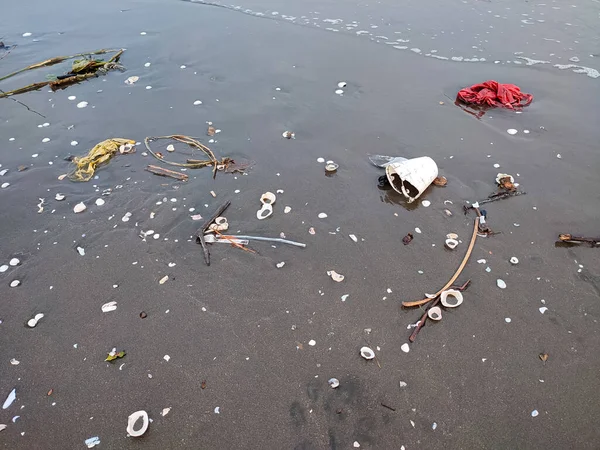 Garbage dumped on the sand on the beach. beach polluted by garbage. littering on the beach.
