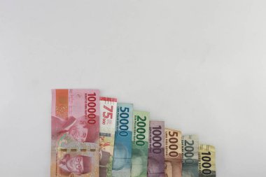 order of the Indonesian rupiah currency from smallest to largest. Banknotes 100000, 75000, 50000, 20000, 10000, 5000, 2000, 1000 rupiah. with full framing concept. isolated studio photography