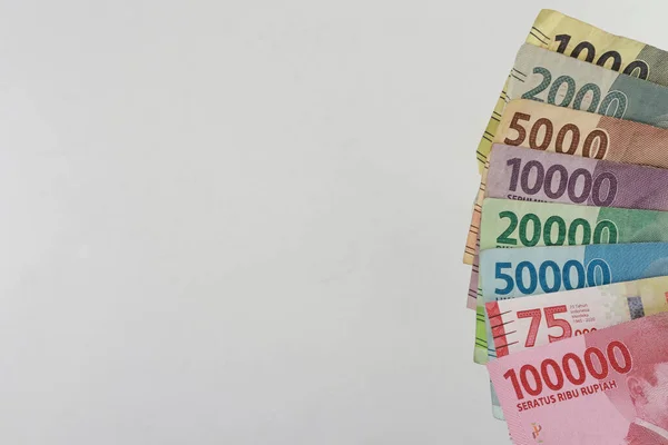 order of the Indonesian rupiah currency from smallest to largest. Banknotes 100000, 75000, 50000, 20000, 10000, 5000, 2000, 1000 rupiah. with full framing concept. isolated studio photography