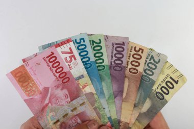 order of the Indonesian rupiah currency from smallest to largest. Banknotes 100000, 75000, 50000, 20000, 10000, 5000, 2000, 1000 rupiah. with full framing concept. isolated studio photography