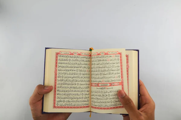 Klaten, Indonesia - March 04, 2023 : reading holy book al quran. lifestyle in Islam. Islamic traditions and beliefs. study the scriptures. activities in the holy month of Ramadan. white background.
