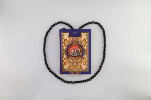 Mushaf or holy book al qur\'an and prayer beads. lifestyle in Islam. Islamic religious traditions and beliefs. study the scriptures. activities in the holy month of Ramadan. isolated white background.