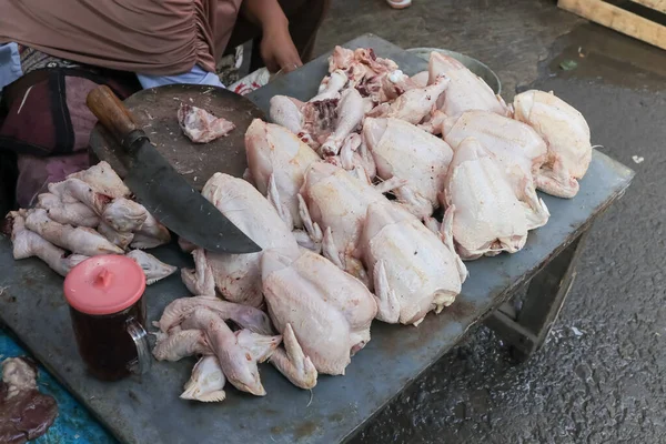 fresh raw chicken. chicken market activity is cutting fresh chicken on the table. minced chicken. activity people.