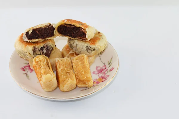 stock image Bakpia Pathok. Indonesian traditional cake. Close up of handmade steamed cakes. various flavors. served on a plate, white background. isolated, photography studio.