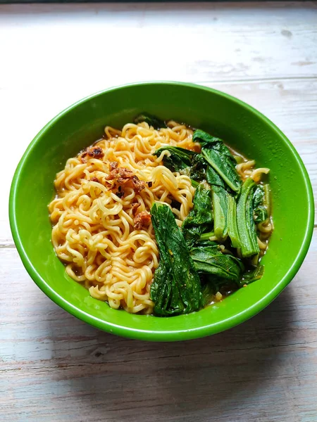 Food instant noodle soup. Boiled noodles with various toppings. in a bowl on the table. fast food hot food suitable eaten during winter or rainy season. no people. studio shoot.