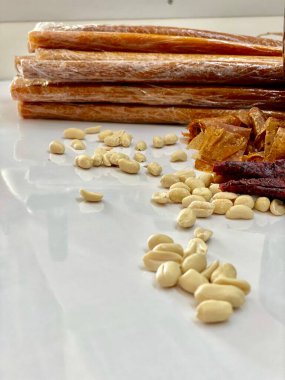 Pastila made of fresh fruit with cups, plates decorated on a white table.