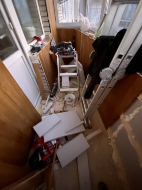 Work on the construction and decoration of the balcony in the apartment with wooden boards