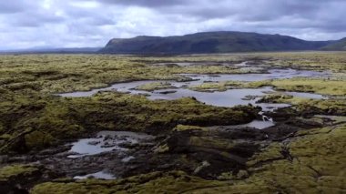 Aerial flying close over moss covered lava rocks in Iceland. High quality 4k footage