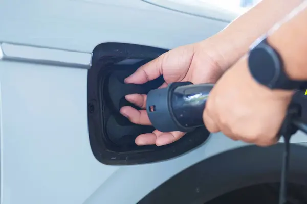 Use your hands to open the electric car charger.