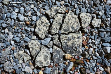 Kırık betonun zemini bir sürü gri taşla kaplıydı..