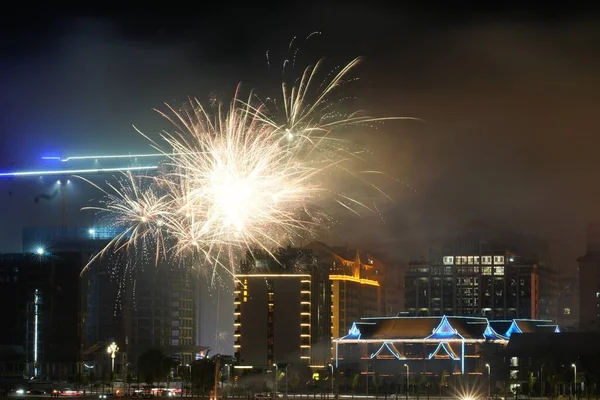 Celebration of fireworks near tall buildings