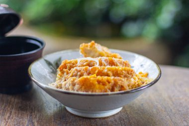 Katsu Don japan style fried pork on rice in bowl focus view blur background