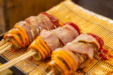 Japanese Pizza or Okonomiyaki roll with chopsticks bacon topping ready to eat