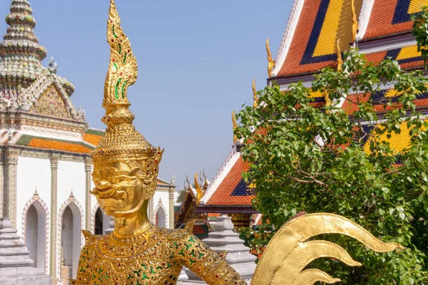 A golden demon statue at Wat Phra Kaew in the Grand Palace in Bangkok, Thailand.