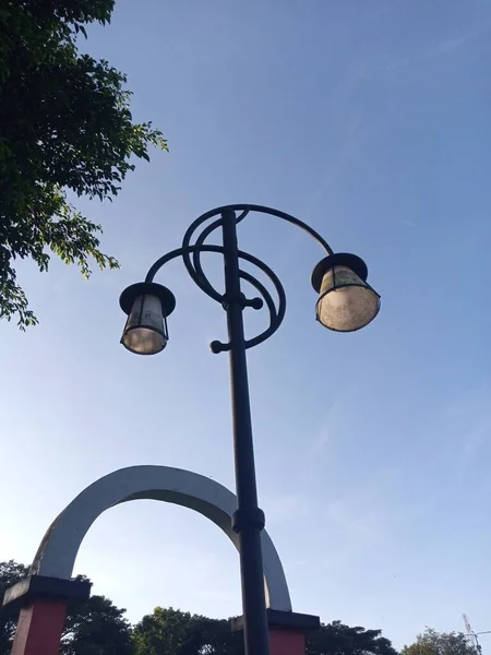 stock image antique garden lamp under the blue sky