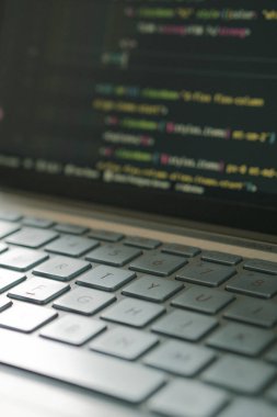 Programming code in laptop with aesthetic keyboard