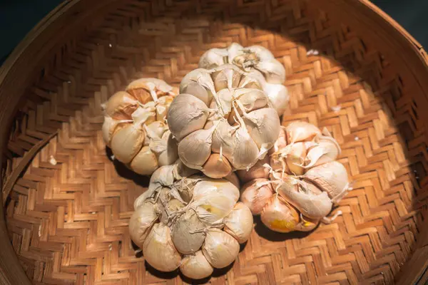 Stock image Close up garlic on rattan basket background. Garlic on wicker basket background