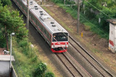 Kereta Api Endonezya Kereta Listrik Pondok Çin istasyonundan geçen Elektrikli Yolcu: Depok, Endonezya - 3 Eylül 2023