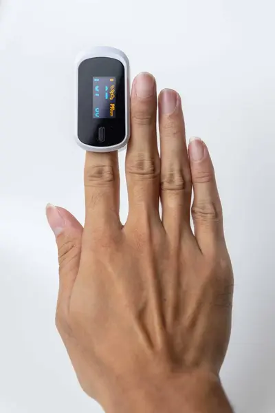 Close up of human finger while using Pulse Oximetry isolated on white background.