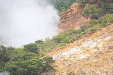 Landscape of Sikidang crater in Dieng, Indonesia with smoke of sulfur. Beautiful scenic in a mountain with sulfur smoke clipart