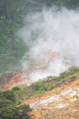 Landscape of Sikidang crater in Dieng, Indonesia with smoke of sulfur. Beautiful scenic in a mountain with sulfur smoke clipart