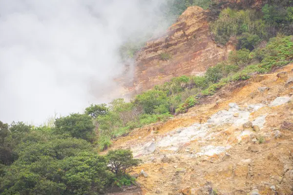 stock image Landscape of Sikidang crater in Dieng, Indonesia with smoke of sulfur. Beautiful scenic in a mountain with sulfur smoke