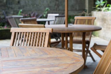 Dışarıdaki restoranda boş tahta sandalyeler ve masalar.