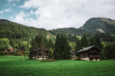 Wooden hut in the alps with mountains in the background Panorama