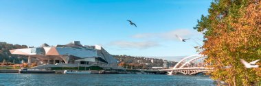 Lyon, France- October 24, 2018: The Musee des Confluences, science centre and anthropology museum. Presqu'le at the confluence of the Rhone and the Saone rivers and the Pont Raymond Barre bride.
