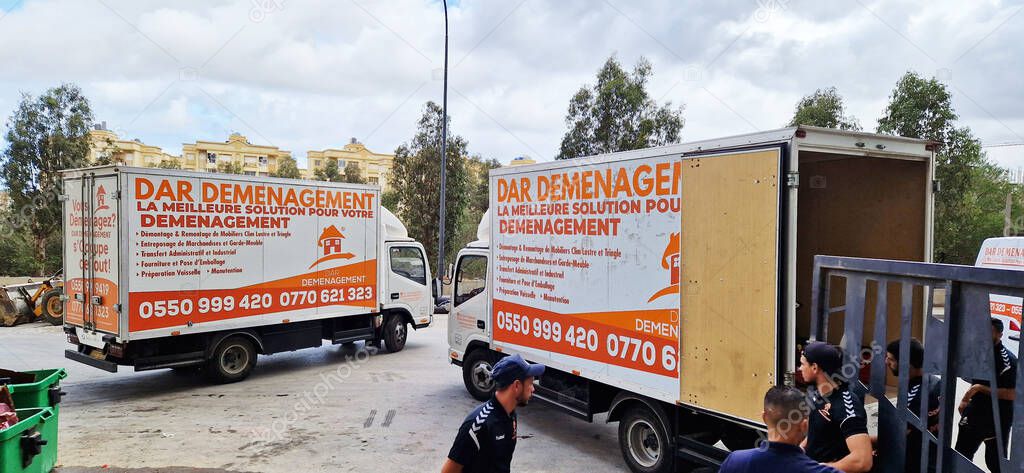 Algeria - April 12, 2025: moving trucks parked with the company logo and French slogan 