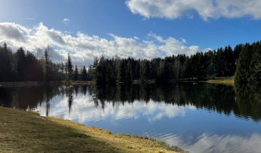 Calm morning at autumn lake in highlands