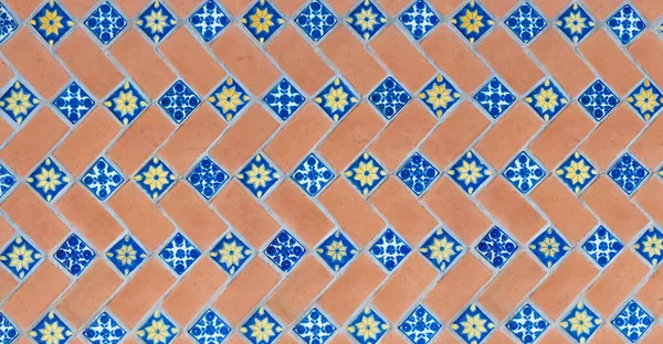 traditional mexican red diagonal bricks wall adornments of handmade hand painted talavera poblana tiles in a touristic church, Puebla, Mexico