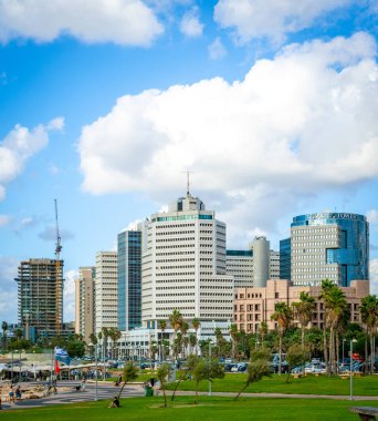İsrail, Tel Aviv - 16 Eylül 2024: Uzakta otelleri olan yeşil çimen, Tel Aviv 'in modern ufuk çizgisini gösteriyor.