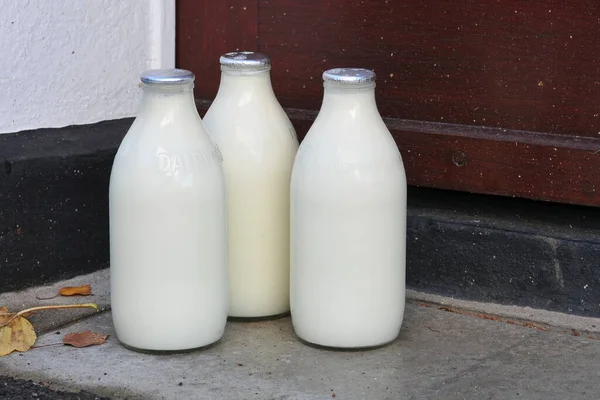 Milk Delivery outside a House\'s Front Door,  bottles milk on doorsteps