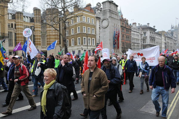 LONDON - MARCH 26: A group of protesters march through the streets of the British capital during a large TUC organized anti-cuts rally on March 26, 2011 in London, UK.