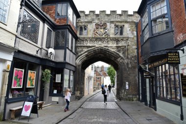 People passes through High Street Gate entering the grounds of the landmark Salisbury Cathedral on August 22, 2017 in Salisbury, UK.  clipart