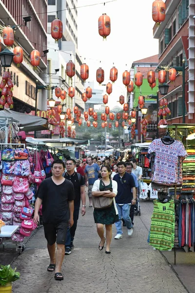 stock image People walk along a market street in Chinatown on June 19, 2015 in Kuala Lumpur, Malaysia. The Malaysian capital city's Chinatown district is a popular destination for its shopping and street food.