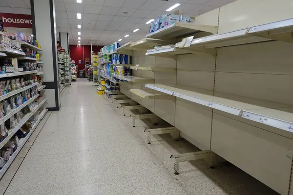 stock image almost empty store shelves, food market interior during covid 