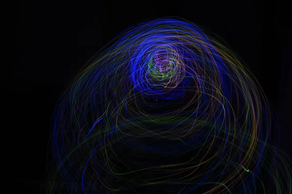 stock image Light painting Abstract colorful irregular lines or patterns on black background with long exposure.