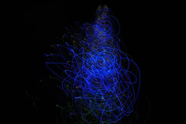 Light painting Abstract colorful irregular lines / patterns on black background with long exposure .