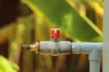 Su borusunu yakın çekim yap. Evin tepesinde kırmızı kapama etiketi olsun.