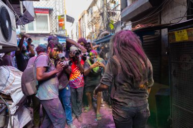 Chennai, Tamilnadu India - 08 Mart 2023: Mint Caddesi, Holi Festival Portresi veya Color Splash Holi kutlamalarında çok sayıda yerli insan tarafından renkli sokak Holi kutlaması