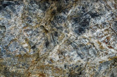 This close-up photo of rocks showcases the rugged, natural beauty of the geological formations. The rough surfaces and textures of the rocks are prominent, with variations in color and shape adding to their unique appeal. 