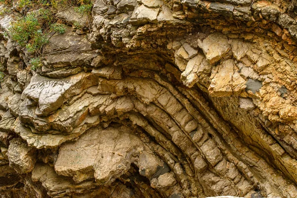 This close-up photo of rocks showcases the rugged, natural beauty of the geological formations. The rough surfaces and textures of the rocks are prominent, with variations in color and shape adding to their unique appeal. 
