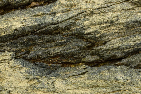 This close-up photo of rocks showcases the rugged, natural beauty of the geological formations. The rough surfaces and textures of the rocks are prominent, with variations in color and shape adding to their unique appeal. 