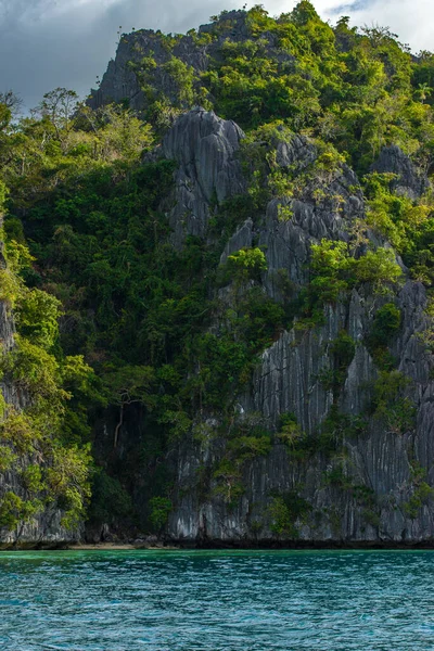 Bu fotoğraf Filipinler 'in şaşırtıcı derecede engebeli kıyı şeridini gösteriyor. Bir dizi kayalık çıkıntılar, dalgalar tarafından pürüzsüz aşınmış, ufukta uzanan, turkuaz deniz çevrelerinde dönerken.