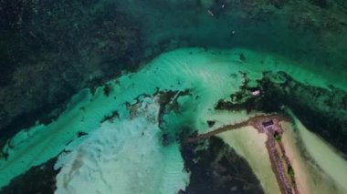 Filipinler 'deki Recife' nin insansız hava aracı görüntüleri. Siyah cebirle çevrili, turkuaz suyla çevrili bir kumsal manzarası. Deneğin 90 derece üstünde sadece tava hareketi ile çekilir..